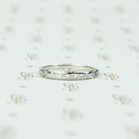 channel set diamond white gold band with arrow design