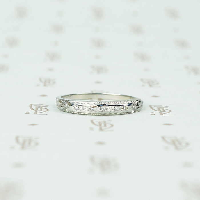 channel set diamond white gold band with arrow design