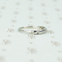 channel set diamond white gold band with arrow design shoulder view