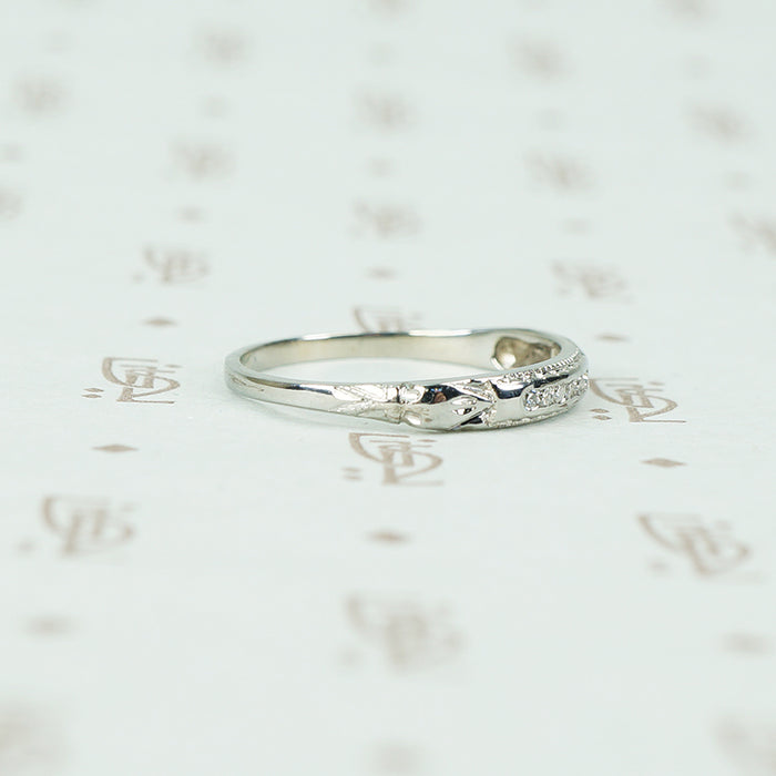 channel set diamond white gold band with arrow design shoulder view
