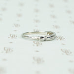 channel set diamond white gold band with arrow design shoulder view