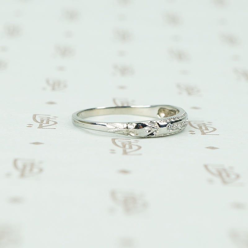 channel set diamond white gold band with arrow design shoulder view