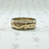 art carved 2 tone vintage wedding band with lightly worn flowers