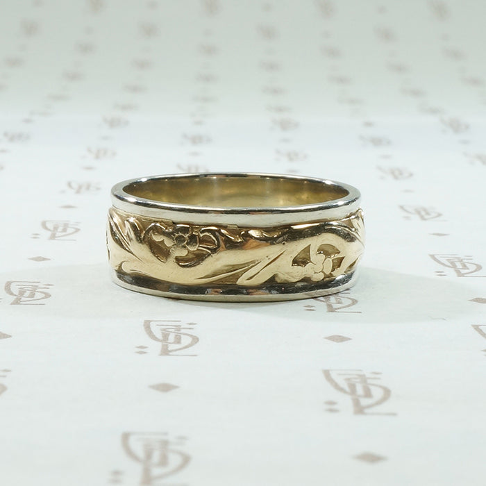 art carved 2 tone vintage wedding band with lightly worn flowers