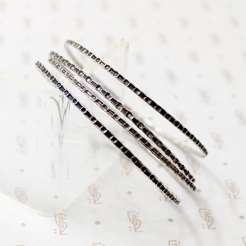 set of four slim sterling silver bangles
