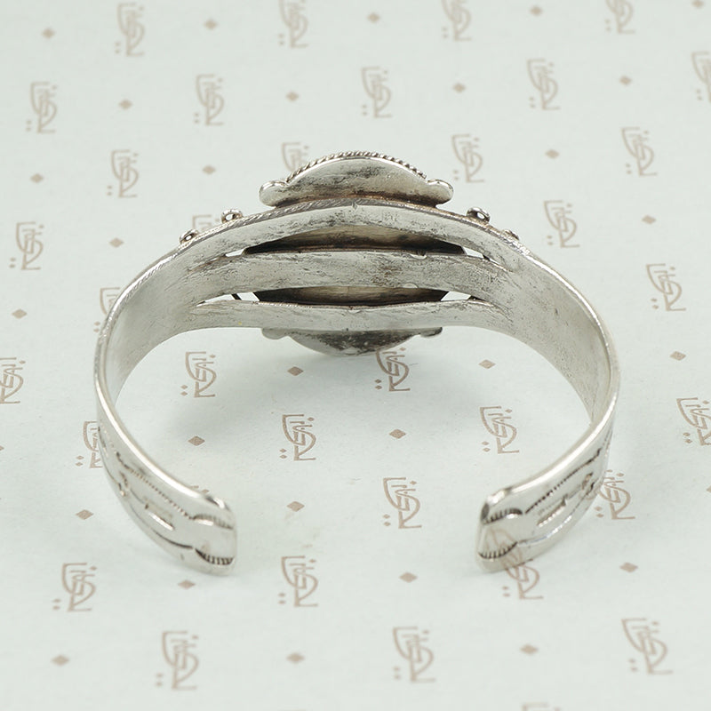 back view american silver cuff with arrow pattern and big turquoise