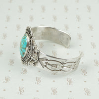side view american silver cuff with arrow pattern and big turquoise