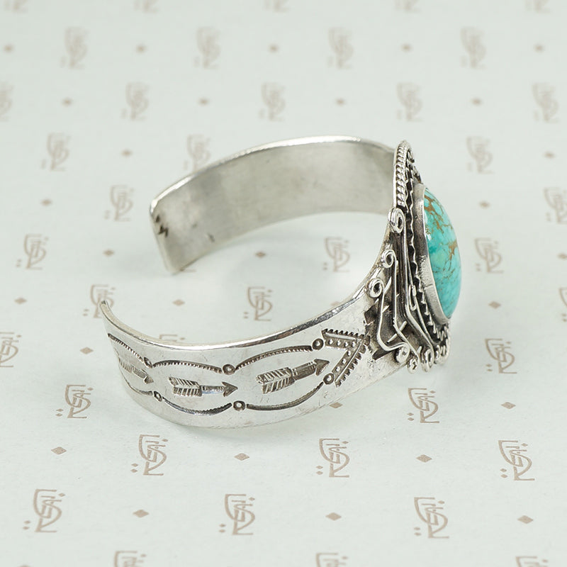 side view american silver cuff with arrow pattern and big turquoise