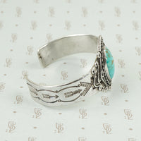 side view american silver cuff with arrow pattern and big turquoise