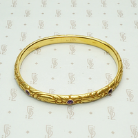 American Art Nouveau 14k Repoussé Bangle Bracelet set with Amethysts. Top view.