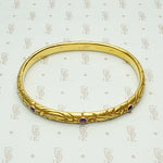 American Art Nouveau 14k Repoussé Bangle Bracelet set with Amethysts. Top view.