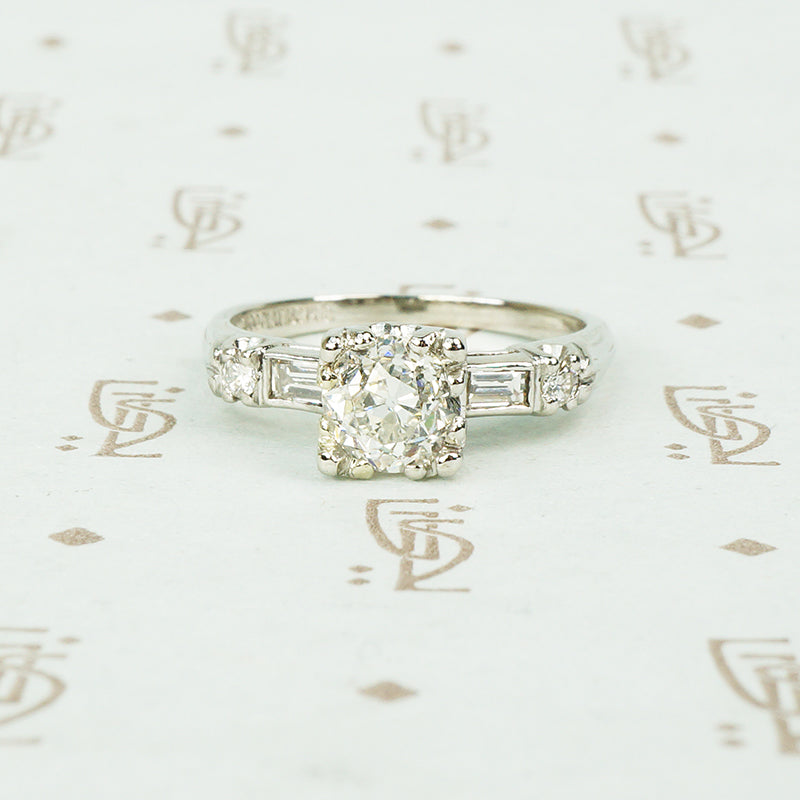 1940's platinum .80 oec diamond ring with diamond baguette sides