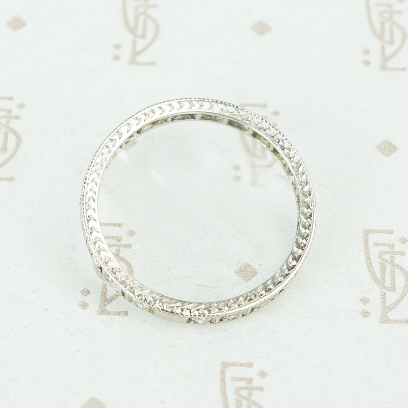 side view of hand engraving platinum diamond eternity band