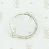 side view of hand engraving platinum diamond eternity band