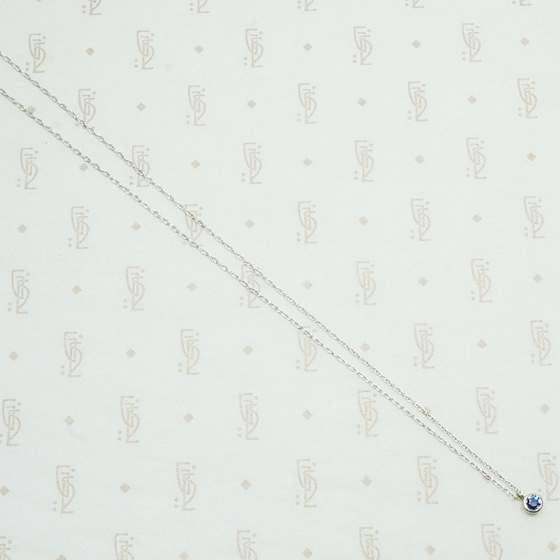 vintage 1/5 carat Montana Sapphire bezel set in recycled 14k white gold and suspend from a matching chain