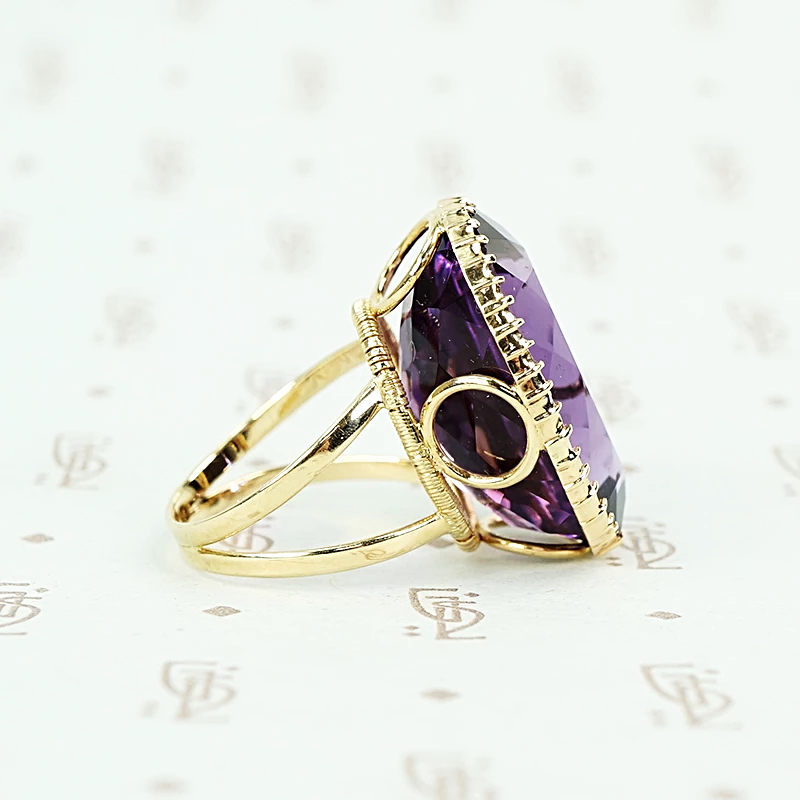 extra big oval amethyst ring in cut back collet side detail of open setting