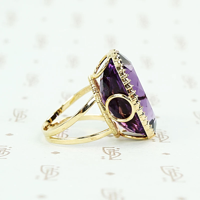 extra big oval amethyst ring in cut back collet side detail of open setting