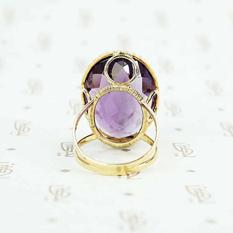 extra big oval amethyst ring in cut back collet side detail of back