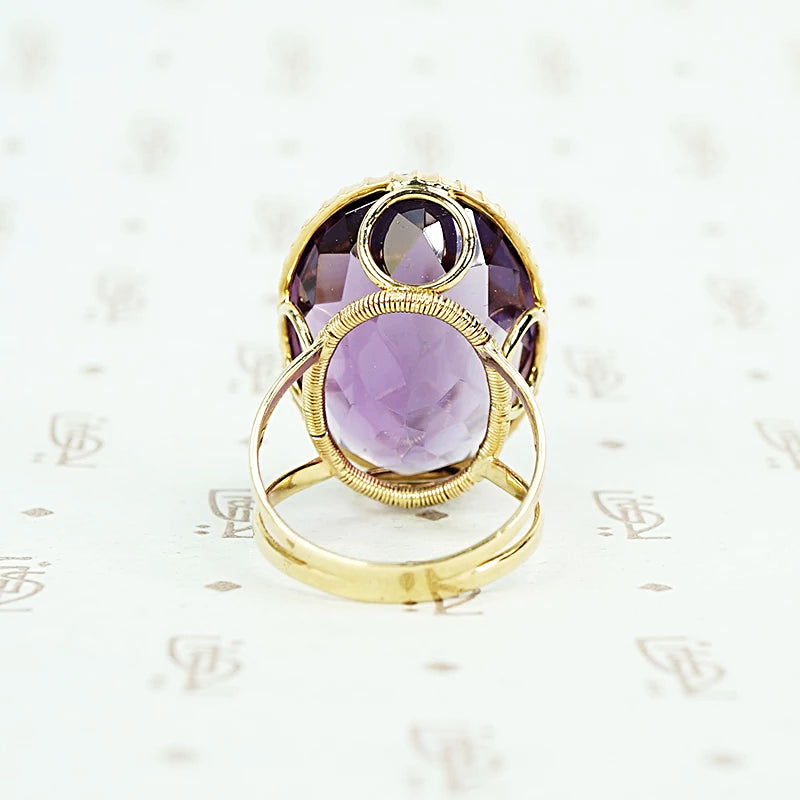 extra big oval amethyst ring in cut back collet side detail of back