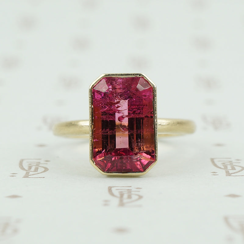 4.47 carat emerald cut pink tourmaline in matte gold ring