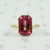 4.47 carat emerald cut pink tourmaline in matte gold ring