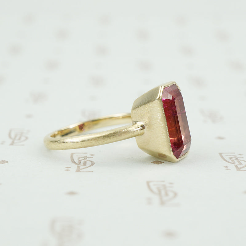 4.47 carat emerald cut pink tourmaline in matte gold ring side