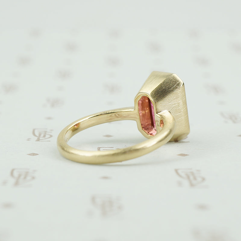 4.47 carat emerald cut pink tourmaline in matte gold ring back