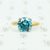 Natural blue zircon solitaire in palladium and 14k yellow gold