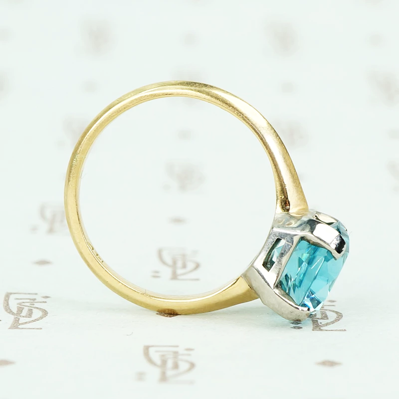 Natural blue zircon solitaire in palladium and 14k yellow gold