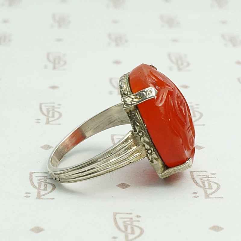 Carved carnelian is silver forget me not setting ring. Right view.