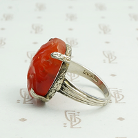 Carved carnelian is silver forget me not setting ring. Left view.