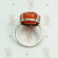Carved carnelian is silver forget me not setting ring. Top view.