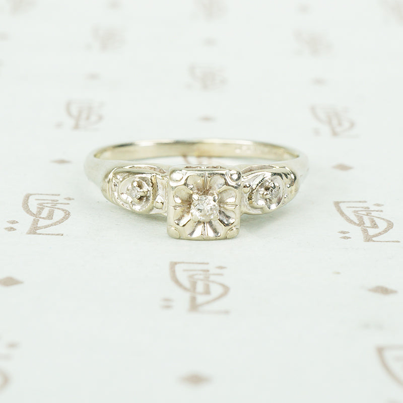 vintage white gold diamond set flower engagement ring