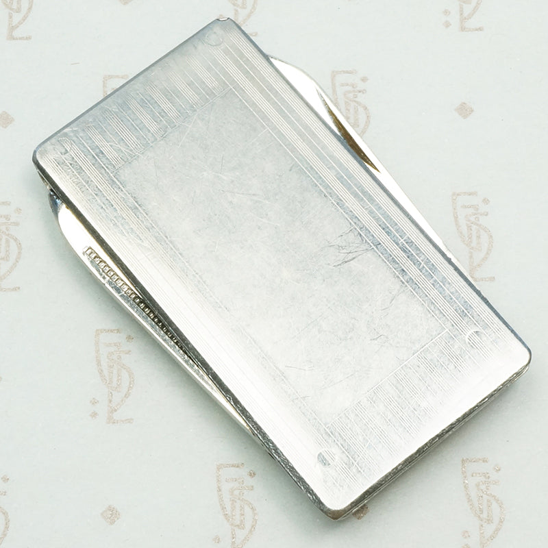 vintage money clip with pocket knives and nail files