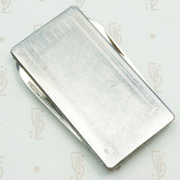 vintage money clip with pocket knives and nail files