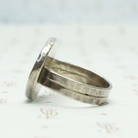 Roman Coin in Handmade Silver Ring, side view.