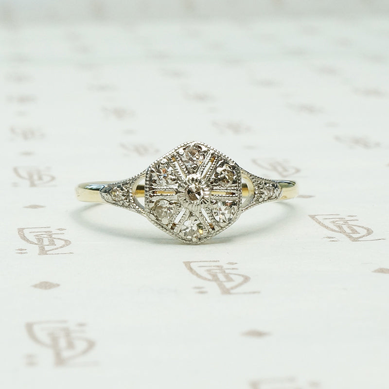reminescient of a compass rose design on an antique map this antique ring is platinum on 18k yellow gold and set with 9 tiny round diamonds