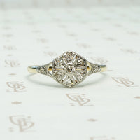 reminescient of a compass rose design on an antique map this antique ring is platinum on 18k yellow gold and set with 9 tiny round diamonds