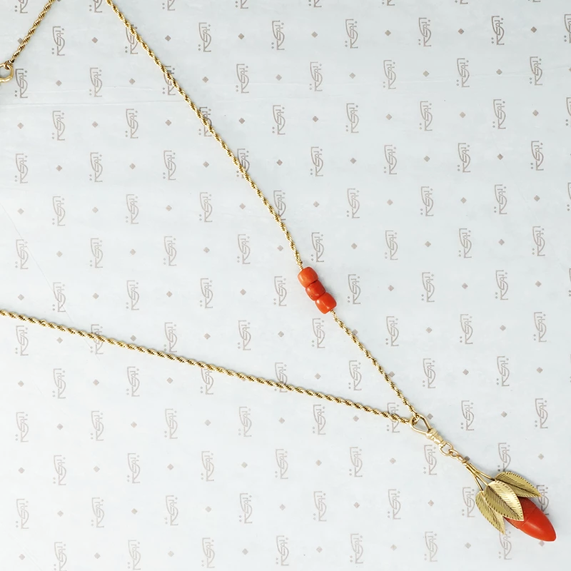 coral and gold acorn on a gold chain