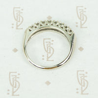 flat side view of 1940's wedding band showing individual u shaped settings holding each of the 8 round diamonds