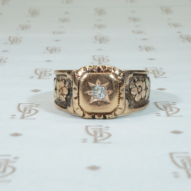 elaborately decorated victorian cigar band set with omc diamond and covered in tri color gold flowers