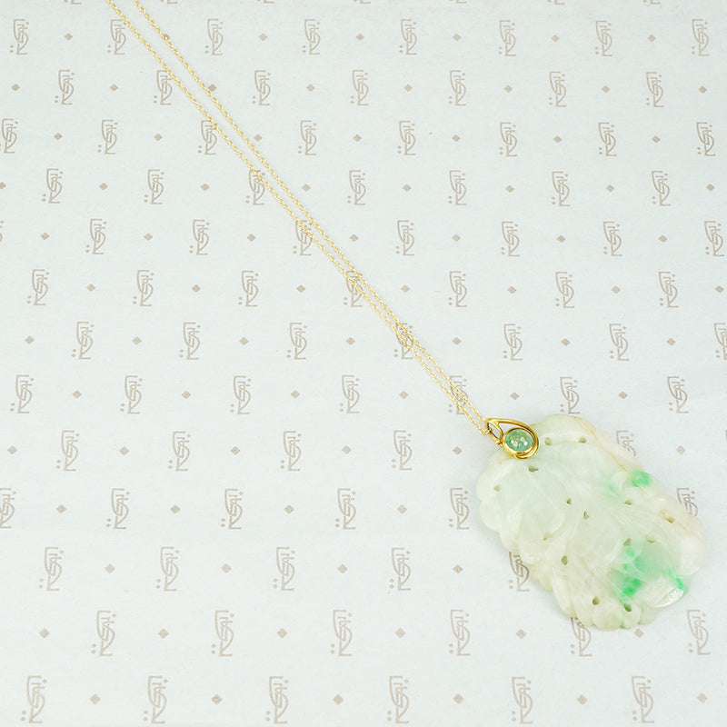 jade carved pendant set with 22k gold and emerald