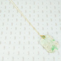jade carved pendant set with 22k gold and emerald