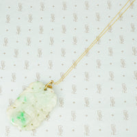 Hand Carved Antique Jade suspended from 22k Gold and Emerald