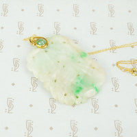 Hand Carved Antique Jade suspended from 22k Gold and Emerald