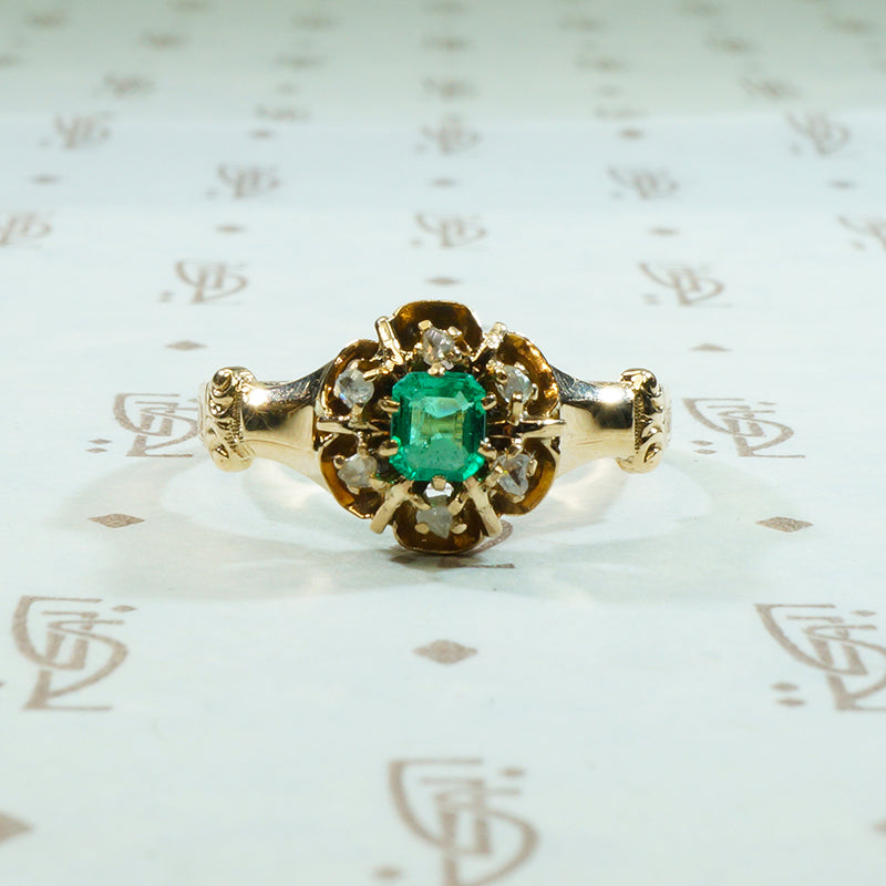 beautiful emerald surrounded by rose cut diamonds in 10k yellow gold ring circa 1880