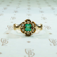 beautiful emerald surrounded by rose cut diamonds in 10k yellow gold ring circa 1880