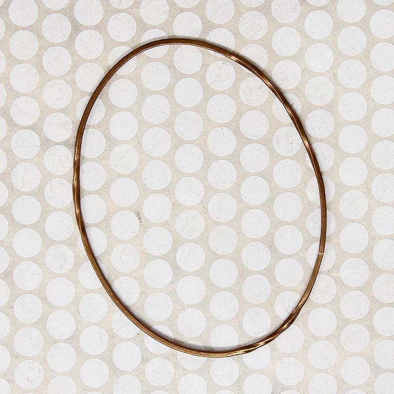 The Endless Twist Oval Bangle in Bronze from Allie B.