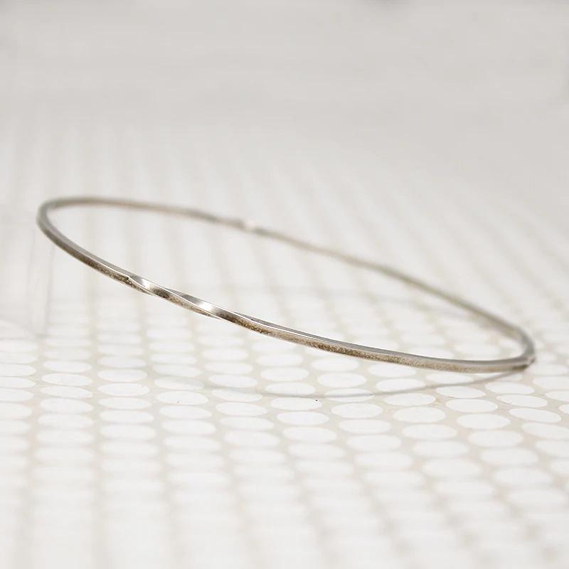 The Endless Twist Oval Bangle in Sterling from Allie B.