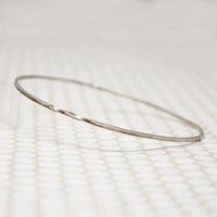 The Endless Twist Oval Bangle in Sterling from Allie B.